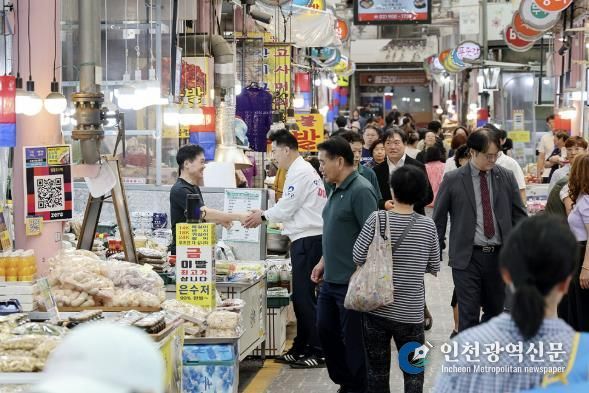 오언석 도봉구청장이 지난 26일 지역 내 한 전통시장을 찾아 상인과 손을 맞잡고 있다.