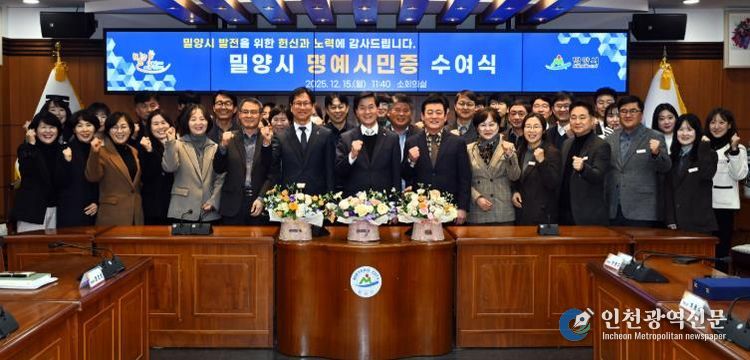 2: 15일 밀양시청 소회의실에서 열린 명예시민증 수여식 참석자들이 함께 기념 촬영을 하고 있다.